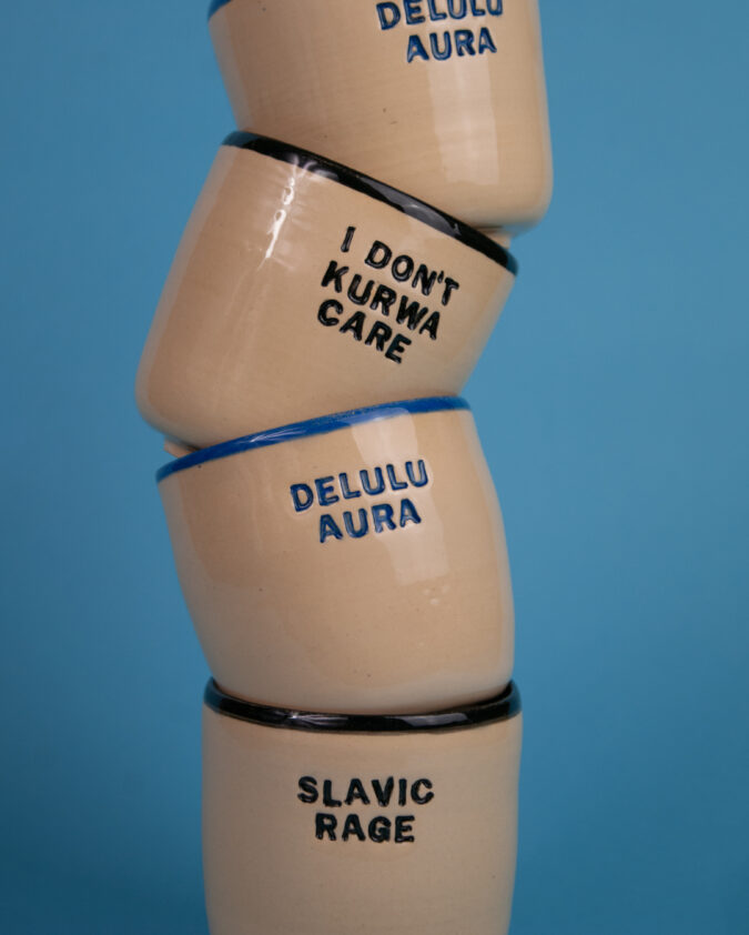 kompozycja z ceramicznych kubków z napisami